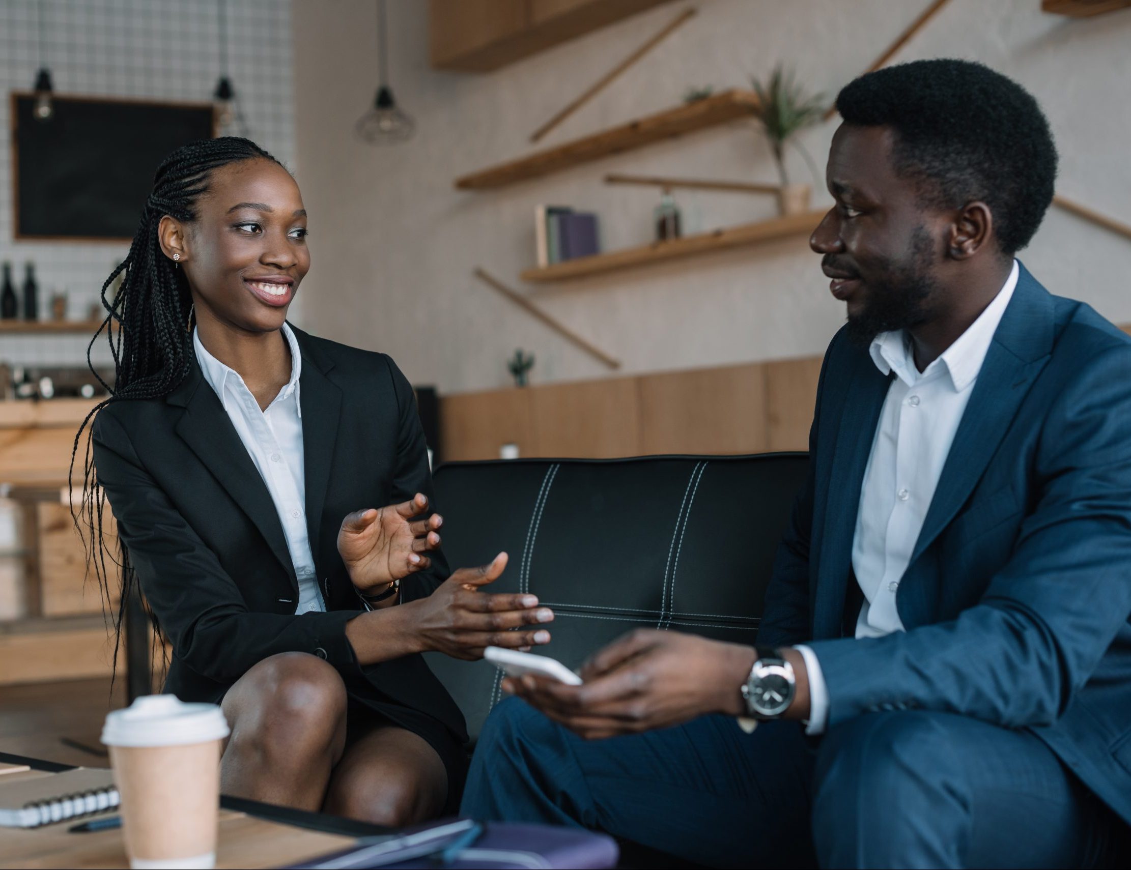 portrait of smiling african american business partners having conversation in cafe