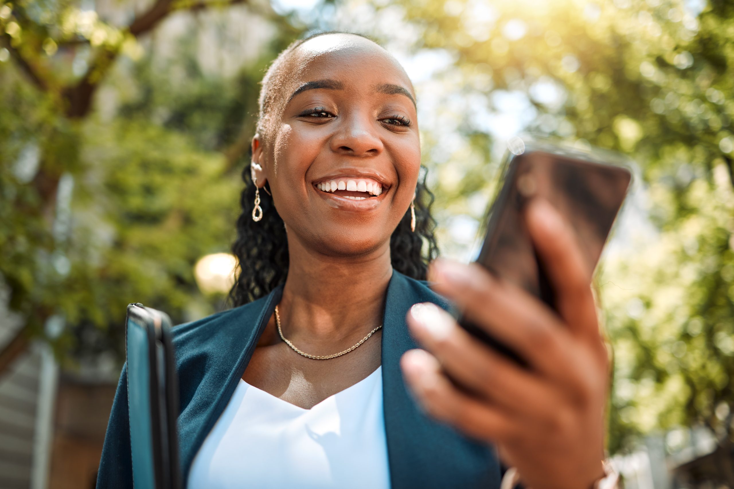 happy-black-woman-phone-and-city-for-social-media-2023-07-13-00-19-44-utc