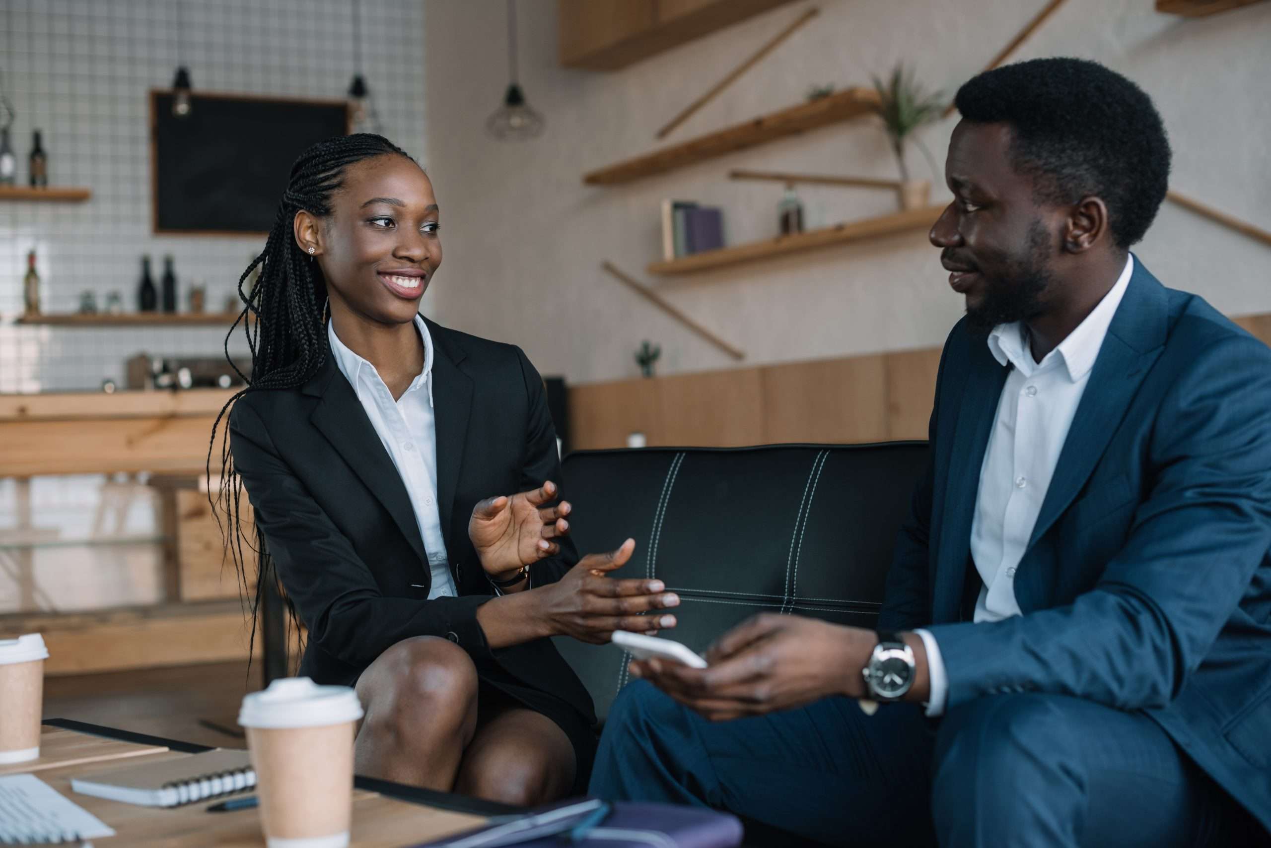 portrait of smiling african american business partners having conversation in cafe