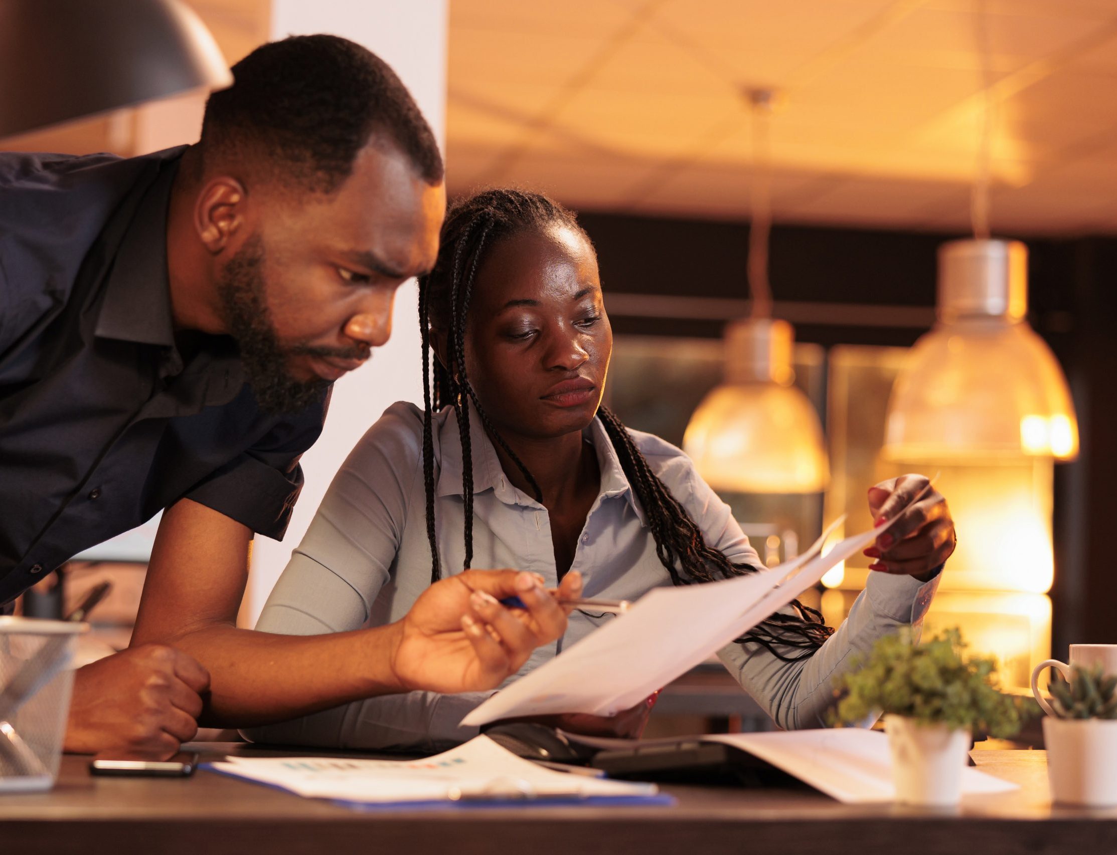 Team of african american business partners analyzing documents