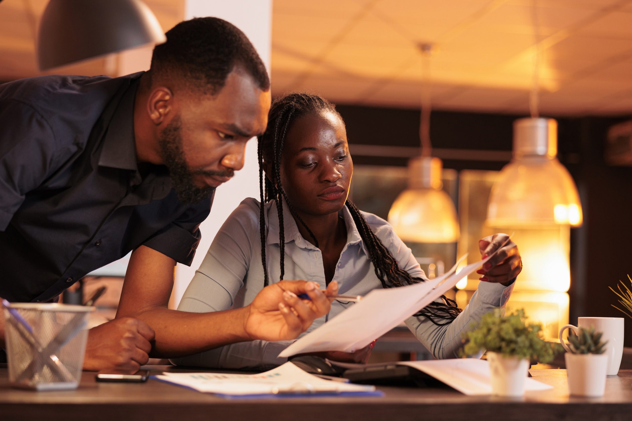 Team of african american business partners analyzing documents