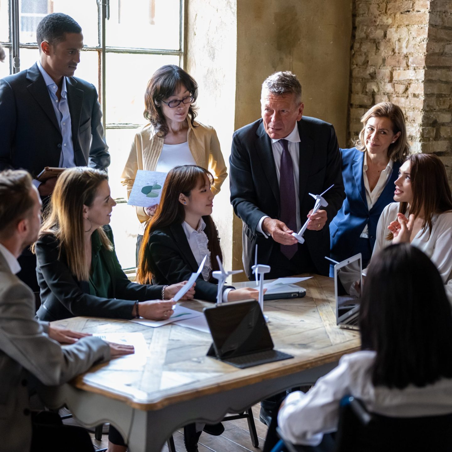 Meeting of entrepreneurs and engineers at the discussion table on energy projects from renewable and sustainable sources for the environment, international teamwork briefing