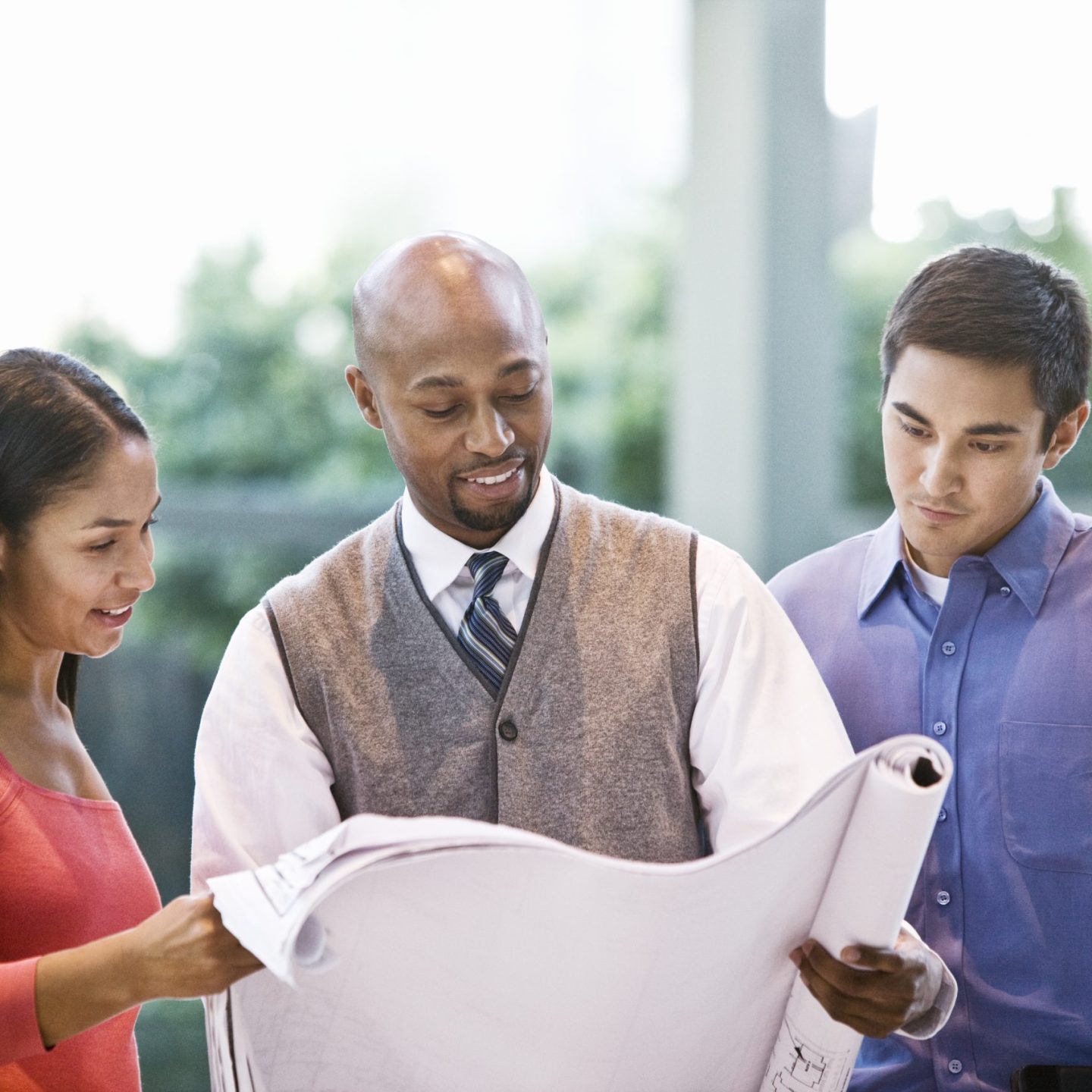 Mixed race team of business people at a table in a business center.