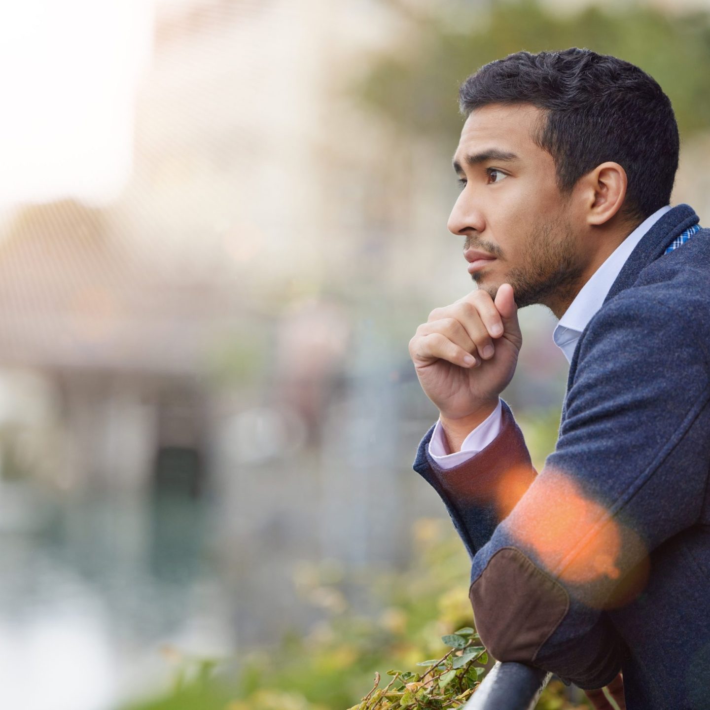Thinking back to happier times. Shot of a young businessman lost in thought