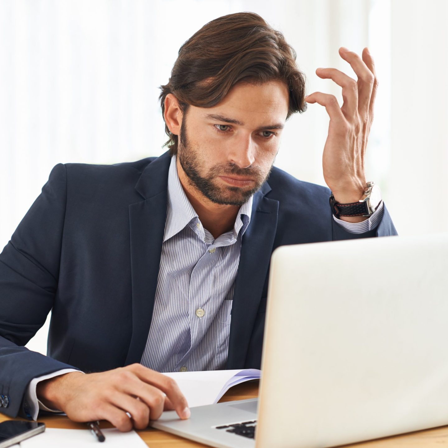 This is going to be one of those days. A frustrated businessman working on his laptop